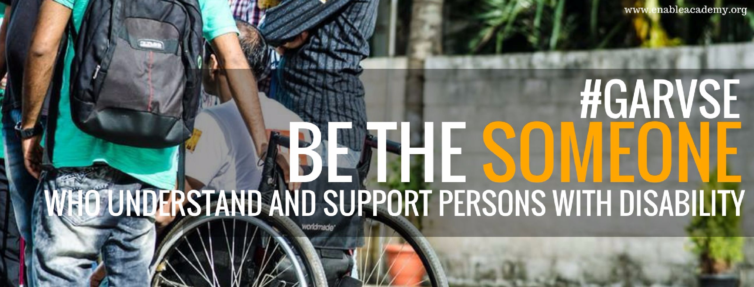 Garvese: Be the someone who understands and supports persons with disability. Picture shows the back of 3 people. Person in the middle is a person in a wheelchair.