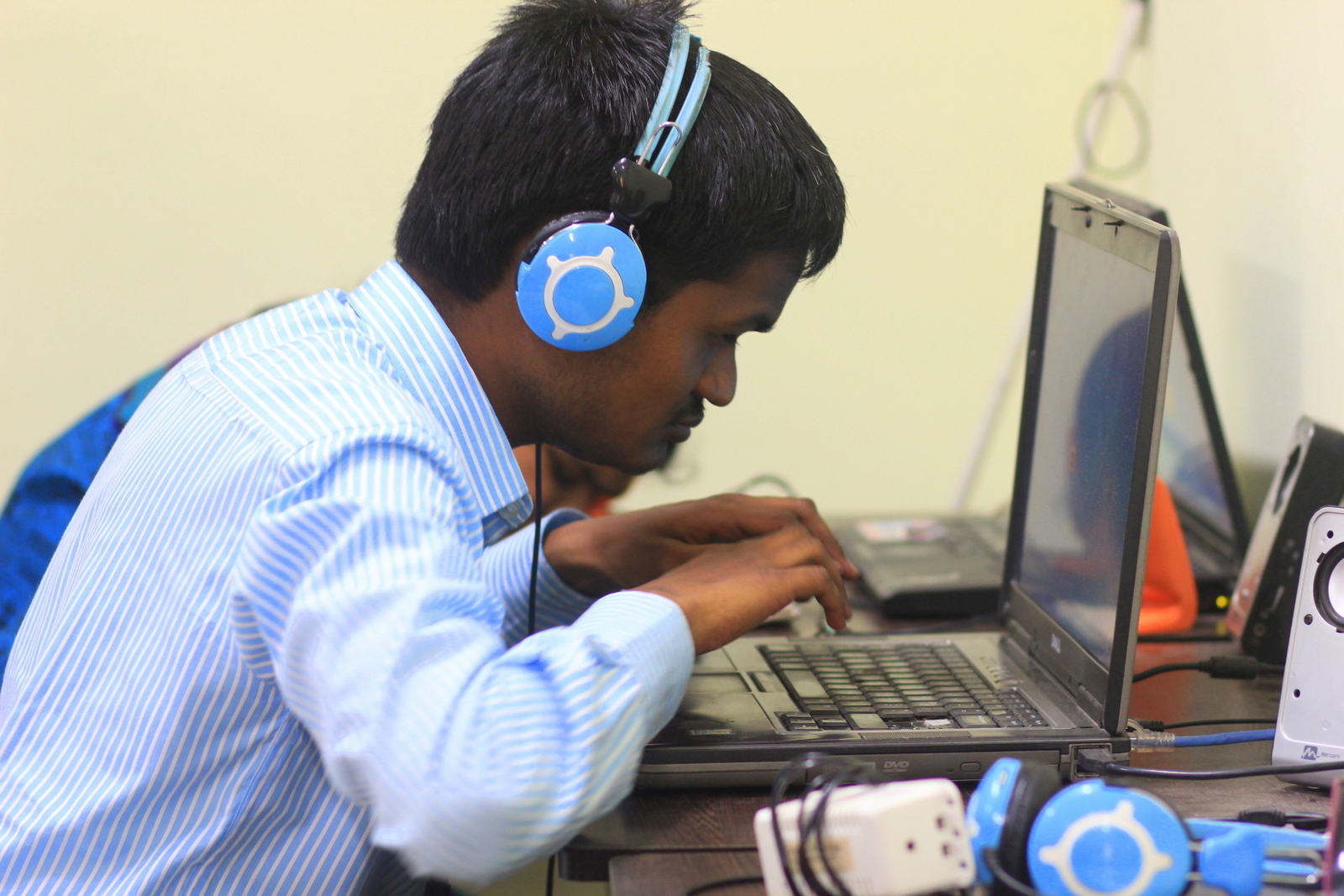 Person with vision impairment using laptop with headset