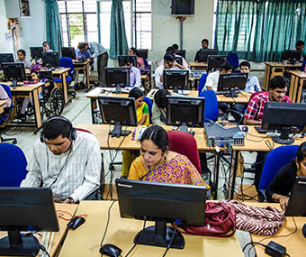 Visually impaired participants working on computers in a training